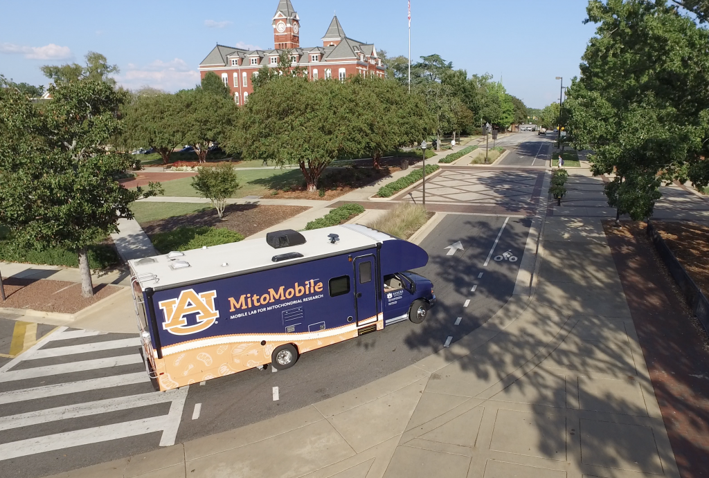 MitoMobile driving on Auburn University's campus with Samford Hall in the background